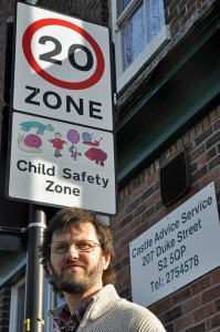 Graham Wroe with 20mph sign outside Castle Advice Centre